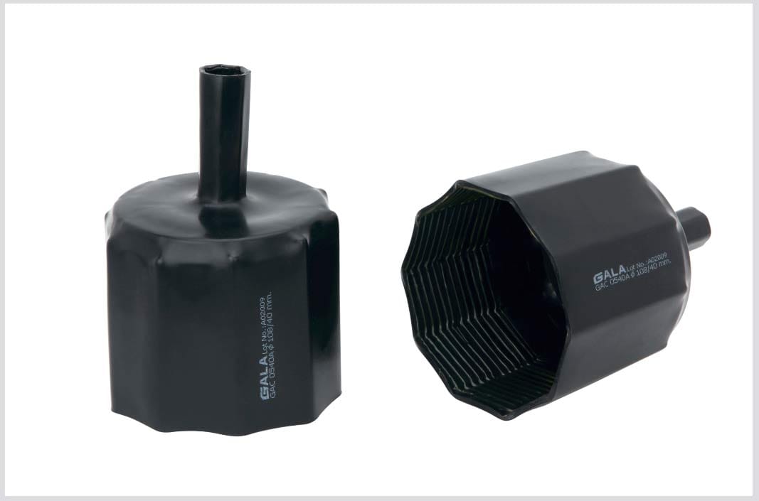 Heat-shrinkable anode cap: a wide moulded anode end stepping down to a narrow spout that closes over the lead wire.
